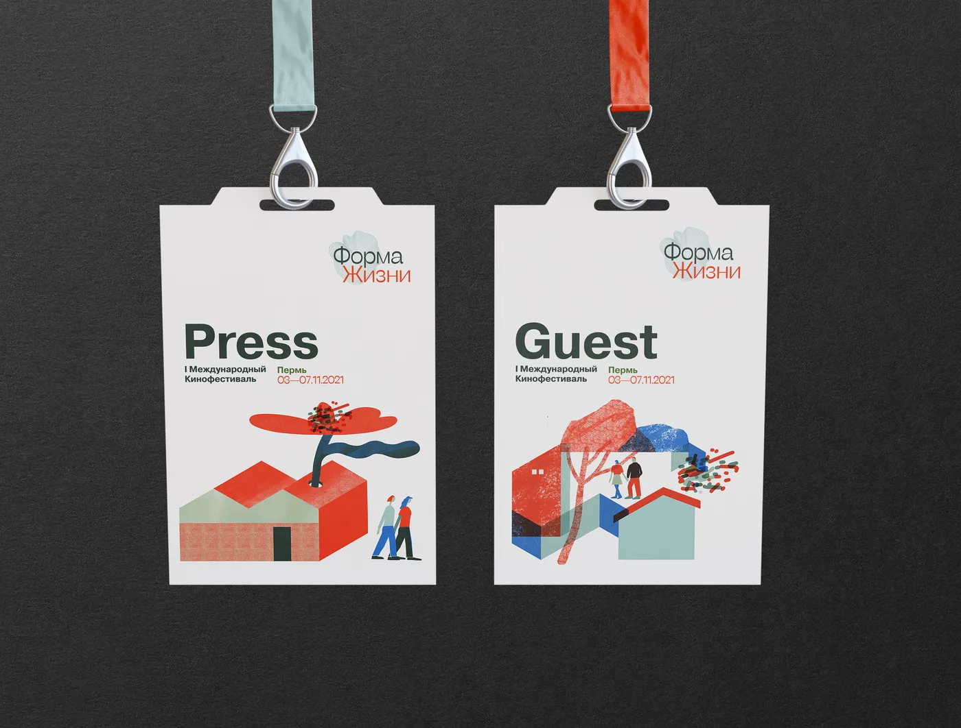 Two accreditation badges on lanyards, marked Press and Guest, each with a different illustrated scene.